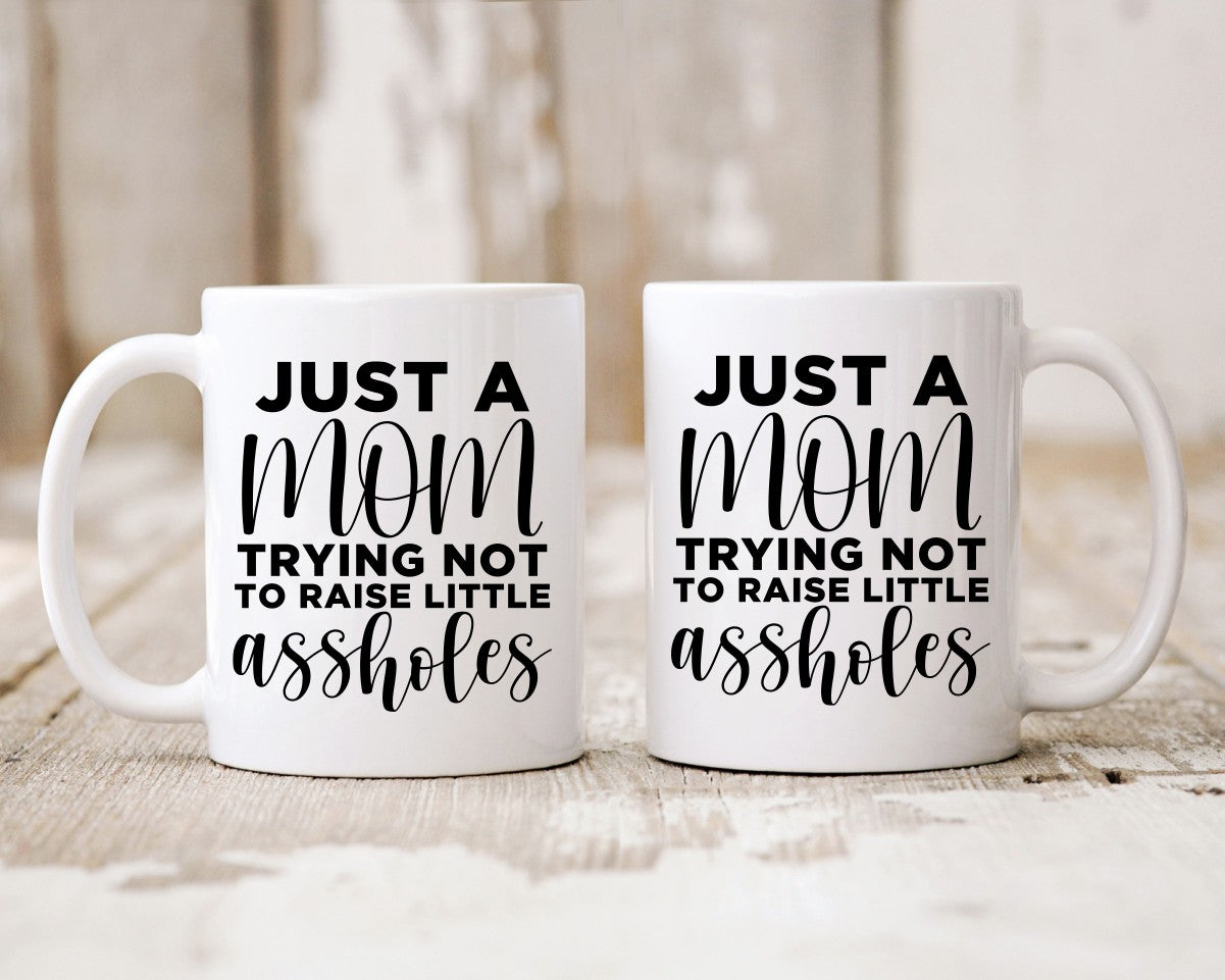 Just A Mom Trying Not To Raise Little Assholes Mom Coffee Mug