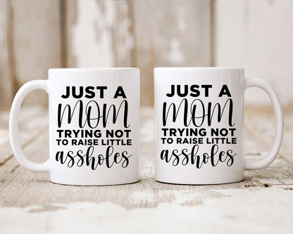 Just A Mom Trying Not To Raise Little Assholes Mom Coffee Mug